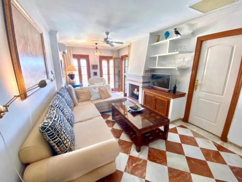 a living room with a couch and a coffee table at Luxury Puebla Aida with Golf & Sea View in Mijas Costa