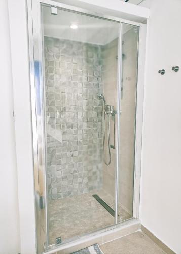 a shower with a glass door in a bathroom at Villa CostaMare - enjoy lazy days on the private Pool-Jacuzzi in Pefki Rhodes