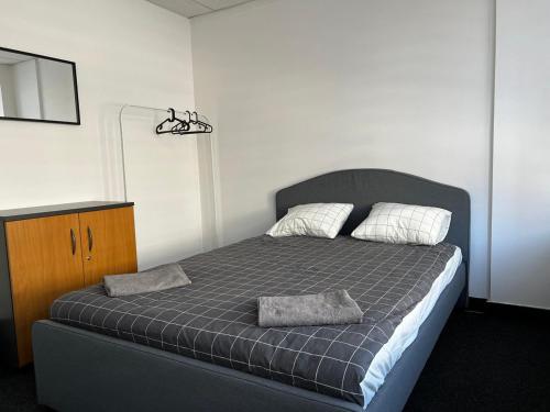 a bedroom with a bed with two pillows on it at Aleja "Solidarności" in Warsaw