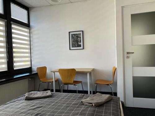 a bedroom with a bed and a table and chairs at Aleja "Solidarności" in Warsaw
