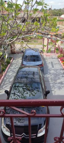 two cars are parked in a parking lot at Maria's home in Órmos
