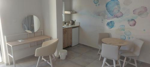 a kitchen with a table and chairs and a mirror at Eleana Nature & Art in Khóra Sfakíon