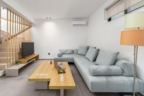 a living room with a couch and a table at Kalma Luxury Villas in Kalamata