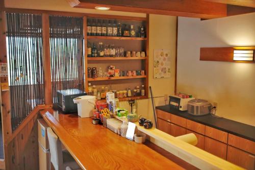 a kitchen with a wooden counter top in a room at 湯布院我楽珍民泊Yufuin Garakuchin in Yufuin