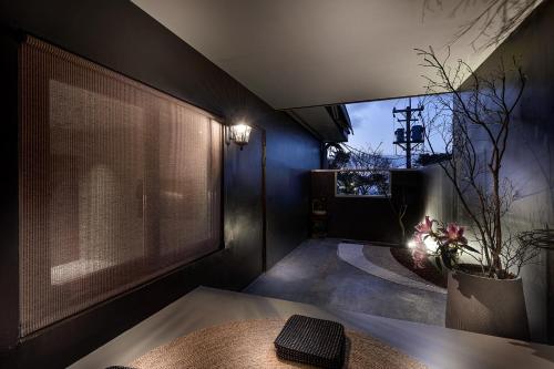 a room with a table and a large window at Daybreak in Jiufen