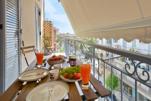 a balcony with a table with food and fruit on it at Saroko House in Corfu