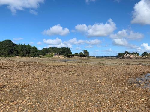 an empty beach with a house in the background at Amour Amour Love Room in Penvénan