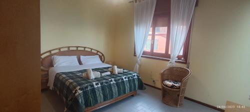 a bedroom with a bed and a window at La Timpa in Acireale