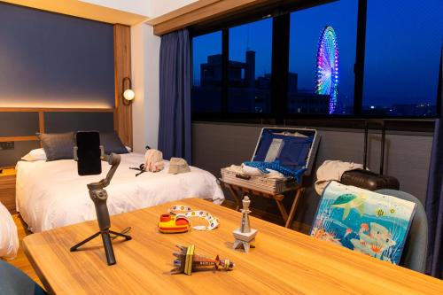 a hotel room with two beds and a desk with a laptop at HOTEL SAILS in Osaka