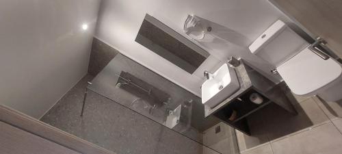 a bathroom with a sink and a mirror at Eleana Nature & Art in Khóra Sfakíon