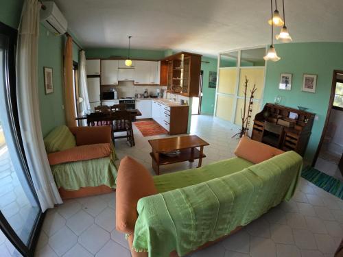 a living room with a couch and a kitchen at Nice house by the sea! in Epanomi