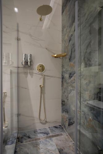 a shower with a glass door in a bathroom at President Hotel&Restaurant&SPA in Trostyanets