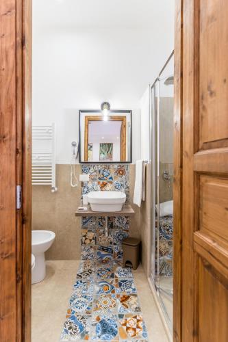 a bathroom with a sink and a toilet at Mama Tita Rooms and Breakfast in Palermo