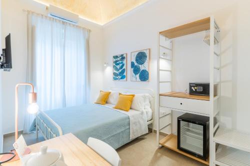a small bedroom with a bed and a desk at Mama Tita Rooms and Breakfast in Palermo
