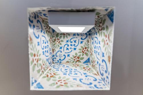 a room with a chair with blue and white porcelain at Mama Tita Rooms and Breakfast in Palermo
