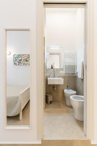 a bathroom with a sink and a toilet and a tub at Mama Tita Rooms and Breakfast in Palermo