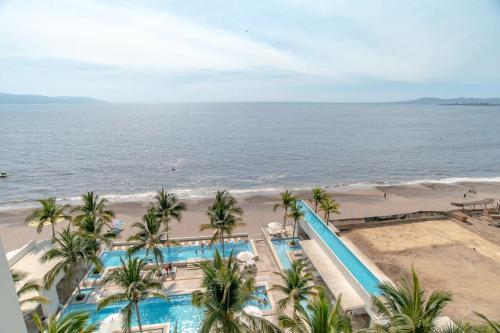 an aerial view of the beach and pool at the resort at Harbor 9005 Beachfront 2bdr by Moikkarentals in Puerto Vallarta