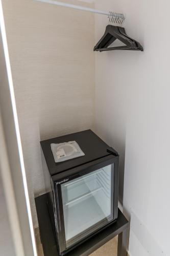 a black tv sitting on a table in a room at Mama Tita Rooms and Breakfast in Palermo