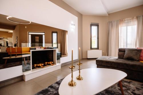a living room with a fireplace and a couch at Palaz Villa in Ayios Kirikos