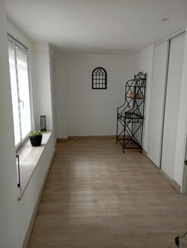 an empty room with white walls and a wooden floor at Chez Isa in Blâmont