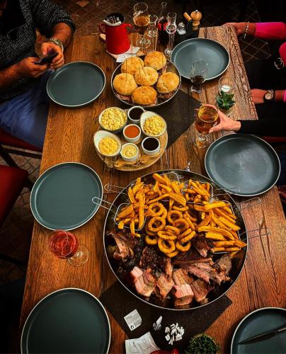 a wooden table topped with a table full of food at Révész Hotel, Restaurant and Rosa Spa in Győr