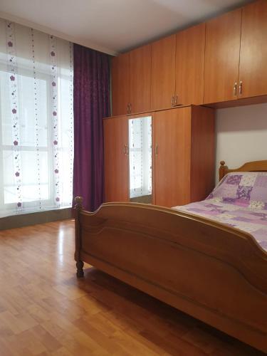 a bedroom with a bed and wooden cabinets at Garsoniera in Dorohoi