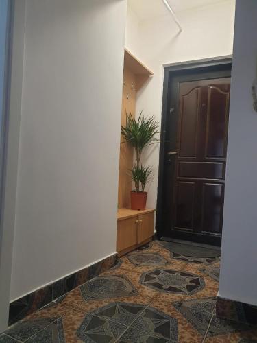 a hallway with a door and a tile floor at Garsoniera in Dorohoi