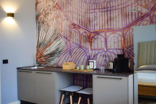 a room with a desk with two stools in front of a mural at GuerriniBNB Civico 5 in Manerbio