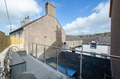 a balcony with a view of a building at Ferrymans Cottage - Historical Menai Bridge in Menai Bridge