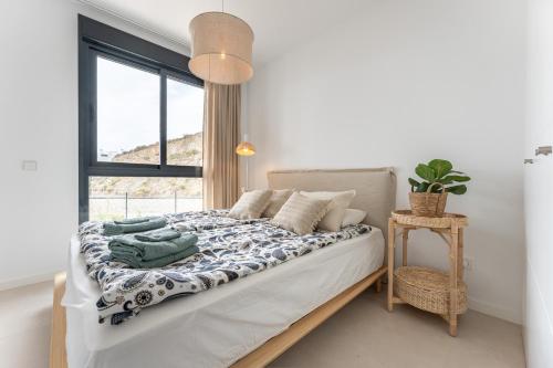 a bedroom with a bed with a window at Holiday apartment Middle Views in Fuengirola