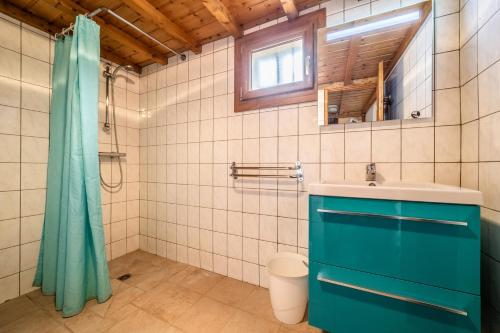 a bathroom with a blue cabinet and a sink at Chalet Nid Zut in Châtel