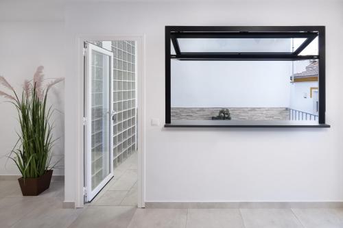 コンペタにあるEl Monteの鏡と窓のある白い部屋