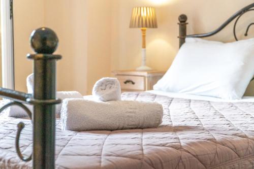 a bedroom with a bed with towels on it at Arianna Studio 15 in Paleokastritsa