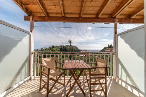 a patio with a table and chairs on a balcony at Arianna Studio 9b in Paleokastritsa