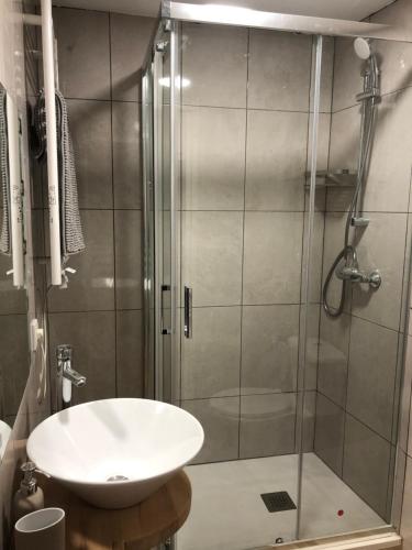 a bathroom with a sink and a shower at La Bodega de Antonio in Faramontanos de Tábara