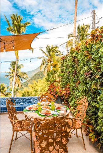 a table and chairs on a patio with a view at Noni's Resort in Alitagtag