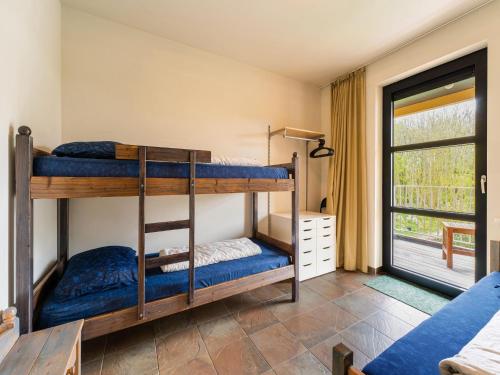 two bunk beds in a room with a window at Charming apartment in Zeeland with beautiful sea view in Cadzand-Bad