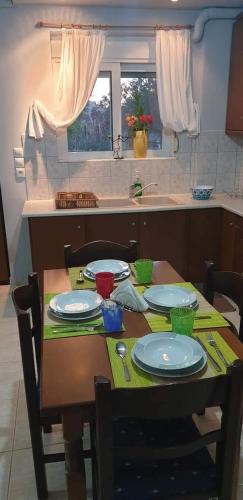 a table in a kitchen with plates on it at Miniera house in Linopótis