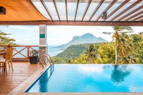 a view of the mountains from a swimming pool at a resort at Noni's Resort in Alitagtag