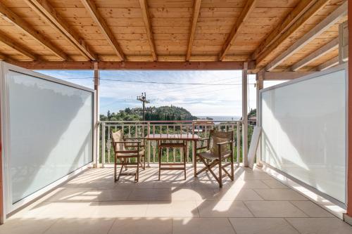 a patio with a table and chairs on a balcony at Arianna Studio 9 in Paleokastritsa