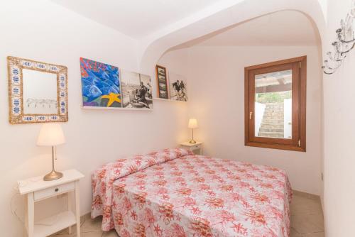 a bedroom with a bed and a window at Villa Bella in Conca Verde