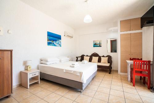 A bed or beds in a room at Kiotari beach garden view-sea view