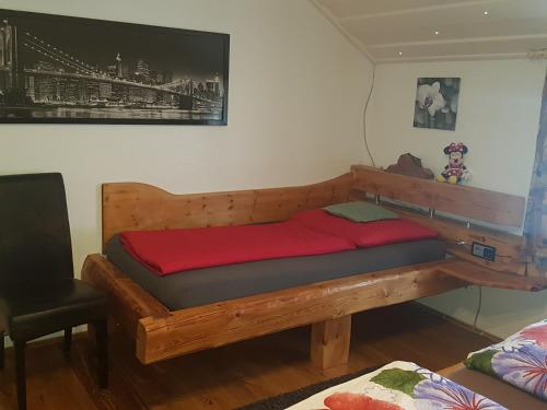 a bed with a wooden frame in a room at Casa Piedro in Starnberg