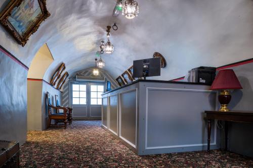 a hallway in a building with aamed ceilings and a room with a counter at Three Crowns Residents in Tallinn