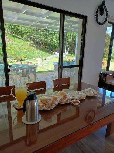 a table with plates of food and orange juice at 印象莊園包棟民宿,一日一組客人,依人數開房 in Xihu