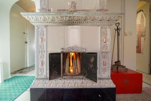 a fireplace with a fire in it in a room at Kodikas Studio in Tampere