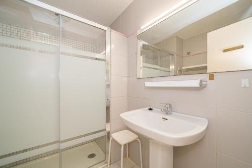 a white bathroom with a sink and a shower at Apartment Sandra by the sea in El Campello