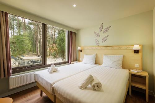 Ένα ή περισσότερα κρεβάτια σε δωμάτιο στο Center Parcs Les Hauts de Bruyères