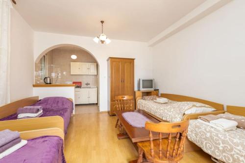 uma sala de estar com 2 camas e uma cozinha em Solo Sole apartman 1- Meljine em Meljine