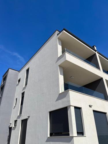 a white building with a blue sky in the background at Sun in Mandre
